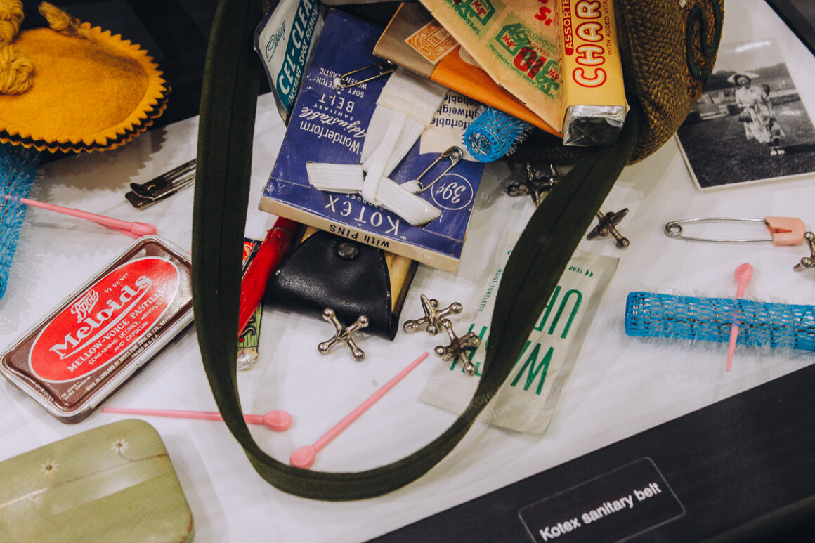 a purse with various items a woman might carry with her