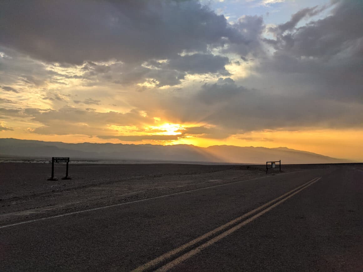 a road and sunset in Death Valley National Park - one of the best road trips from Las Vegas to national parks 