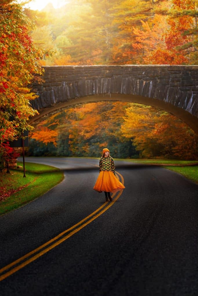 a girl on the road amid fall foliage in Blowing Rock, NC