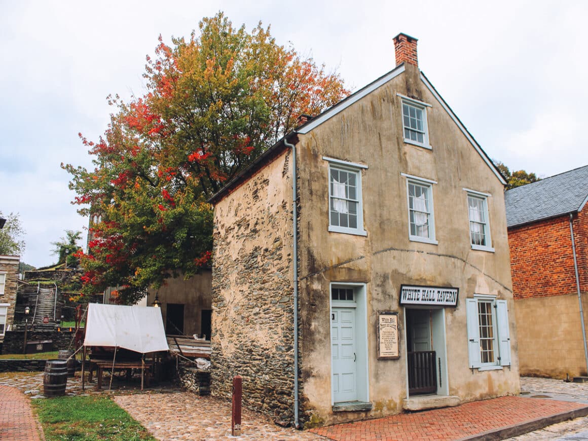 a building in Harpers Ferry West Virginia with fall foliage on the trees