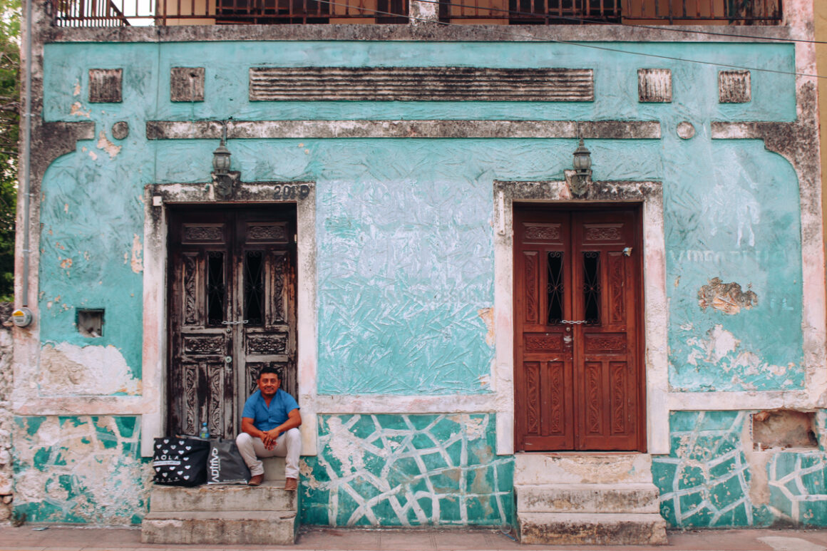 a man sits in front of a building in Valladolid