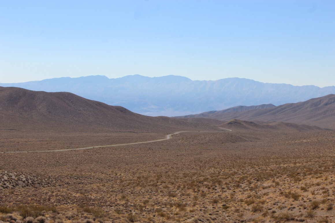 Driving in Death Valley National Park road curving through the mountains