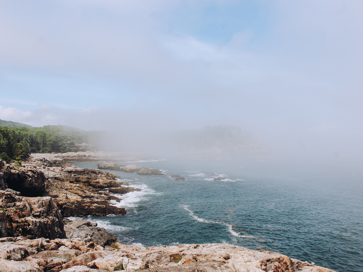 Rocky beach and blue water and waves at Acadia National Park