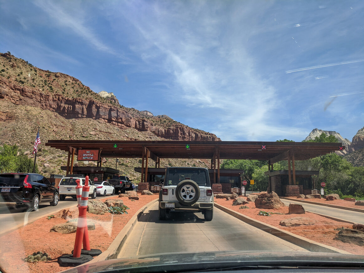 the entrance station with cars in line at Zion National Park