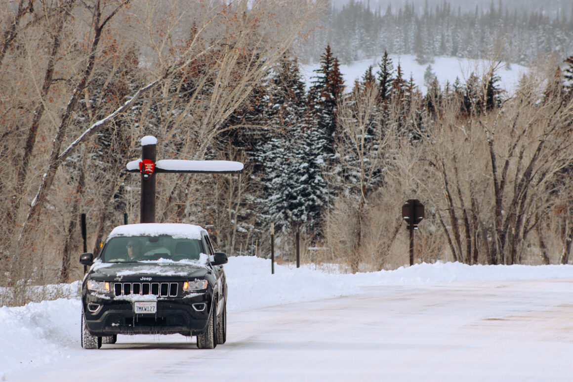 A car on a snowy road in Grand Teton National Park, Wyoming