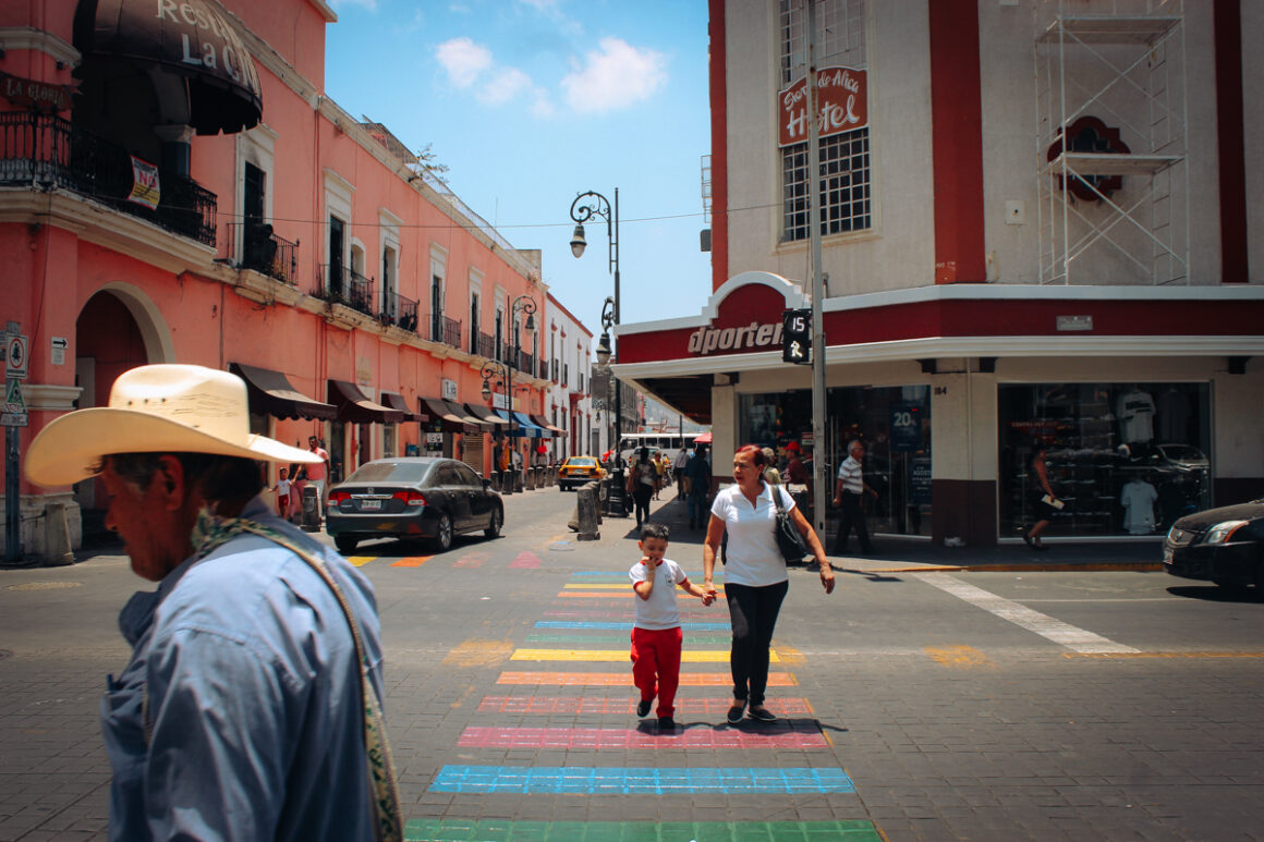 People crossing a street with a rainbow crosswalk in Tepic, Nayarit