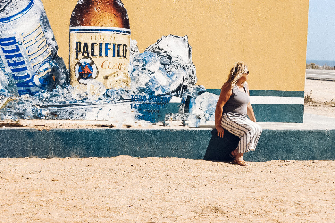 Things to know before visiting Mexico — Lori in front of a Pacifico mural in Baja