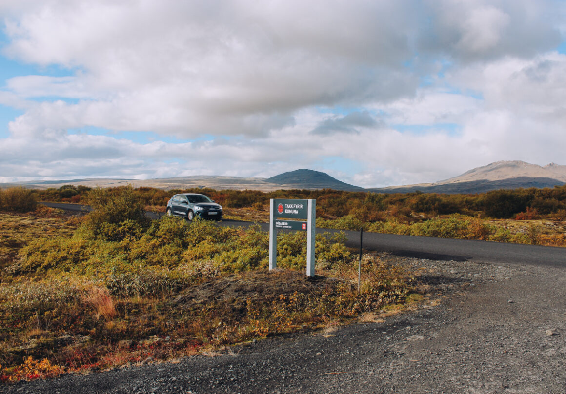 A gray car on the road near Thingvellir National Park in Iceland